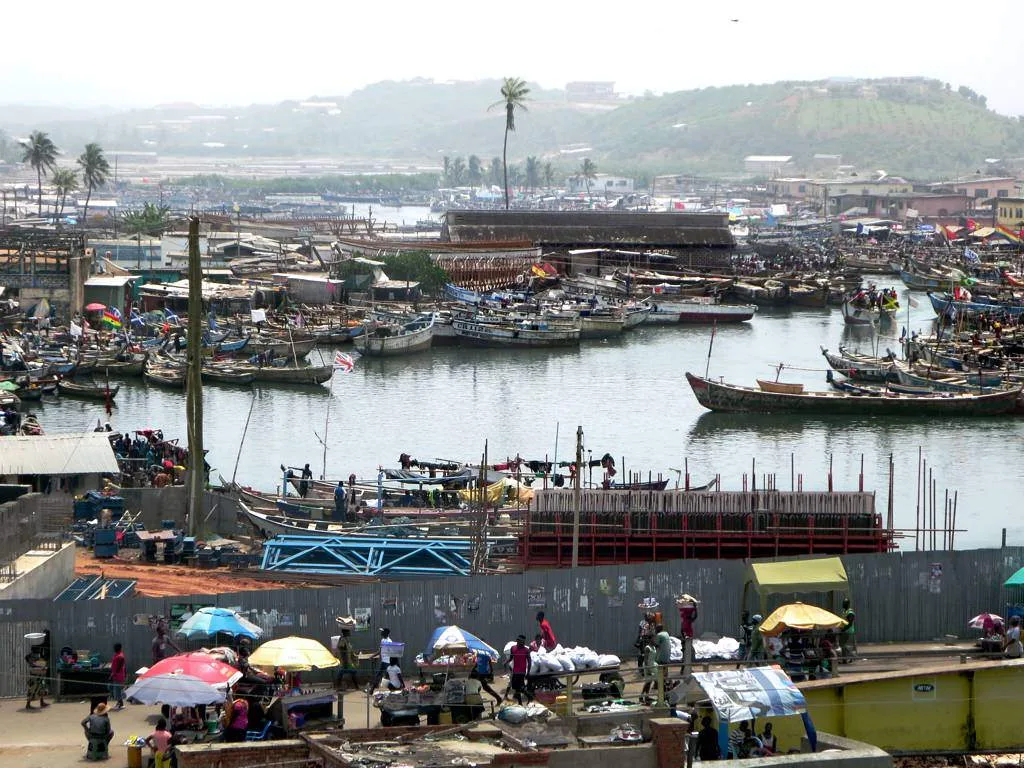 The Benya Lagoon at Elmina, Ghana, is literally packed with pirogues and surrounded by a vast fish market.